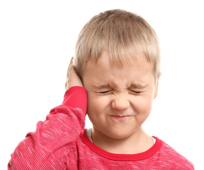 Photo of a young child holding his ear in a painful way