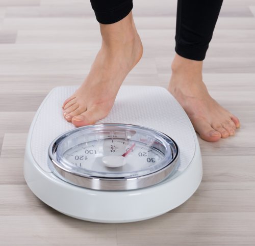 photo of a foot stepping onto a scale